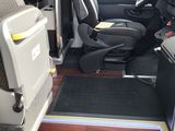 the interior of a van with the door open and the driver ' s seat down