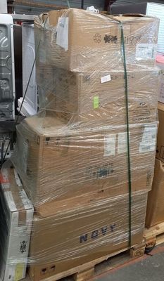 a pile of boxes on a pallet next to a microwave