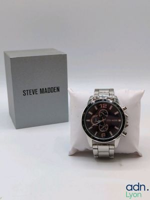 a watch that is sitting on a pillow next to a box