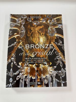 a close up of a book on a table with a chandelier