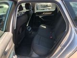 the back seat of a car with the door open and the driver ' s seat down
