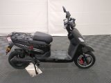 a scooter that is parked on a checkered floor