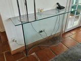 une table en verre sur laquelle est posé un téléphone, dans un salon