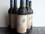 several bottles of wine are lined up on a table