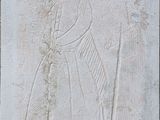 une image représentant un relief en pierre représentant un homme et une femme