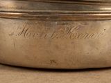 a silver pot with a lid on a table