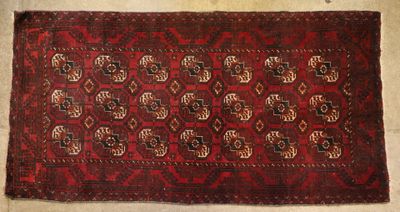 a close up of a red rug on a white floor