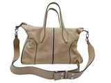 the large beige handbag is sitting on a white surface