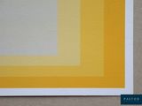 a close up of a piece of paper with yellow and white squares on it