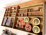 a wooden box with many different types of sewing supplies