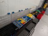 a long line of plastic bins on a conveyor belt