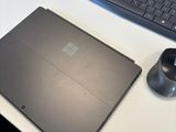 a laptop and mouse on a desk with a keyboard and mouse