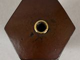 a brown vase that has a hole in it