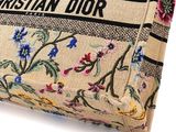 a purse with a floral pattern on it on a white surface