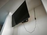 a flat screen tv mounted on the wall in the corner of a room