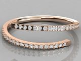 a close up view of a rose gold wedding band with diamonds