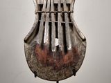 sculpture of a musical instrument on a stand on a white surface