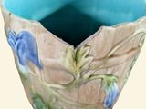a blue bowl with flowers on it on a white background