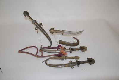 five pairs of scissors and a pair of pliers on a white surface