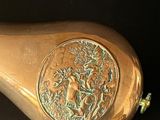 a gold gourd with a picture of a bird on it
