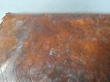 a brown leather bag sitting on top of a table