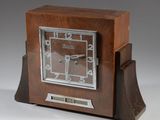 a wooden clock that is sitting on a table