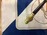 a drawing of a knife and a rope on a blue and white flag