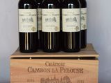 six bouteilles de Château Cambon-la-Ploue dans une caisse en bois
