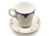 a cup and saucer on a saucer on a white surface