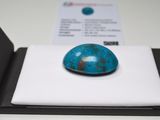 an image of a blue stone sitting on top of a white surface