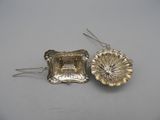 a pair of silver plated earrings with a flower design
