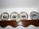 four plates on a shelf with a picture on them