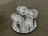 a bunch of glass balls sitting on top of a stand