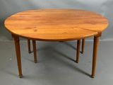 une image représentant une table en bois avec deux pieds et un plateau rond