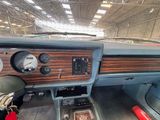 a dashboard of a car with a clock and gauges