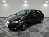 the nissan versa sedan is parked in a clean room