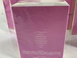three boxes of perfume sitting on top of a white table