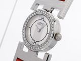 a close up of a wrist watch with a red strap