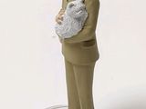 a figurine of a man with a cat on his shoulder