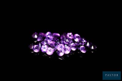 a pile of purple crystals on a black background