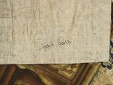 a piece of fabric with writing on it sitting on a table