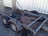 a trailer with a metal frame and a tire on it