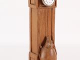 a wooden clock that has a bird on it