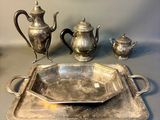 a silver tray with a silver tea pot and a silver tray with a silver tea pot and a silver tray with a silver tea pot and a silver tray