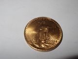 a close up of a gold coin on a white surface