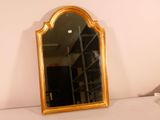 a mirror sitting on a shelf in the corner of a room