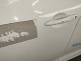 a white car with peeling paint on the side of it