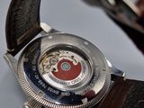 a close up of a wrist watch with a brown strap