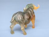 a glass figurine of a bull on a blue surface