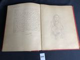 an open book with a drawing of a woman holding a child